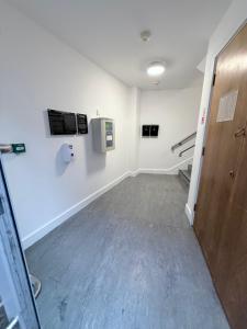 an empty room with a hallway with a door at The Courtyard Retreat in Sligo