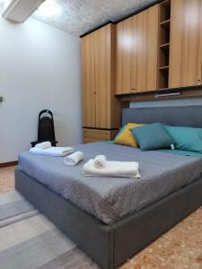 a bedroom with a large bed with towels on it at Cozy Apartments in Lido di Ostia