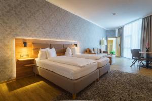Postel nebo postele na pokoji v ubytování Stadthotel Pfeffermühle