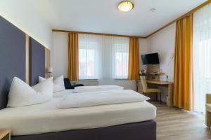 Postel nebo postele na pokoji v ubytování Stadthotel Pfeffermühle