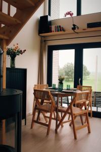a dining room with a table and chairs and a window at Ten Domek in Wola Wereszczyńska +59 photos