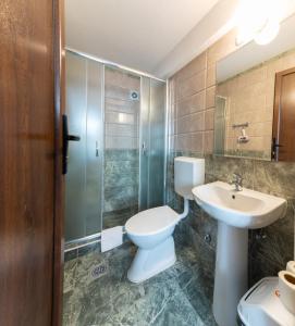 een badkamer met een toilet, een wastafel en een douche bij Konaci Manastir Sveti Stefan - Ohrid in Ohrid +95 foto's