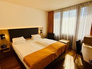 Postel nebo postele na pokoji v ubytování ARVENA Messe Hotel