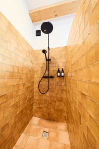 a bathroom with a shower in a brick wall at La Bastide des Oliviers in Le Beausset +26 photos
