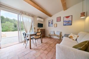 a living room with a couch and a table at La Bastide des Oliviers in Le Beausset