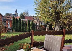 a fence with a table and chairs in a yard at Ferienhaus Petra in Elbingerode +8 photos