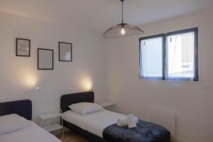 a bedroom with two beds and a window at La Maison Scandi-Loire Classée 3 étoiles à ORLEANS en bord de Loire - 3 chambres avec Garage in Orléans