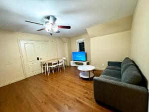 a living room with a couch and a table at Private Bright Coach House - Near Pearson Airport & Downtown Toronto in Brampton
