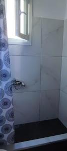 a bathroom with a shower with a window at Villa Kiki by the beach! in Kokkino Nero +22 photos