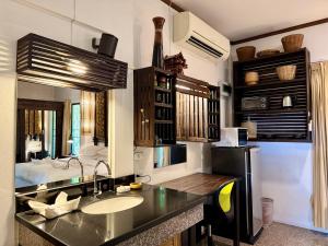 a bathroom with a sink and a counter top at The Green Palm in Haad Pleayleam