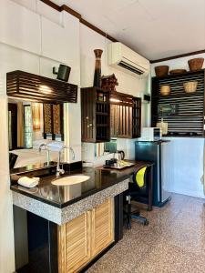 a large kitchen with a sink and a refrigerator at The Green Palm in Haad Pleayleam +8 photos