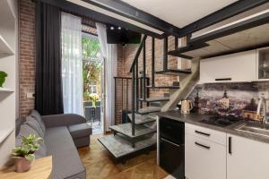 a kitchen and living room with a spiral staircase at Royal mini apart-hotel on Kovzhyna in Lviv