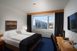 Una cama o camas en una habitación de Hotel Örk