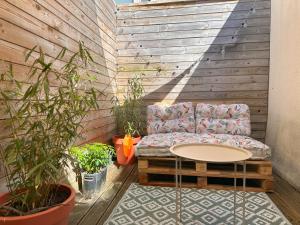 a couch sitting on a patio with a table at La Maison Scandi-Loire Classée 3 étoiles à ORLEANS en bord de Loire - 3 chambres avec Garage in Orléans