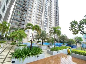 a large building with palm trees in front of it at Luxurious condo with City View in Horizons 101 in Cebu City
