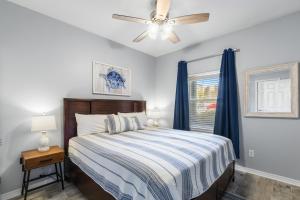 a bedroom with a bed and a ceiling fan at Romar Lakes 103B in Orange Beach