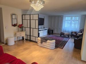 a living room with a couch and a chandelier at Zimmer perla in Chur