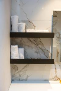 a bathroom with white towels on a shelf at Casa Isabella2 in Ferrara