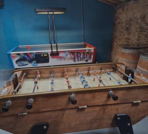 a wooden foosball table with a game in it at Camping La Prévoté in Saint-Hilaire-de-Riez