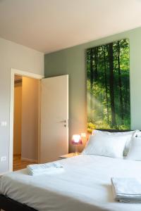 a bedroom with a bed with a large window at Casa Isabella2 in Ferrara