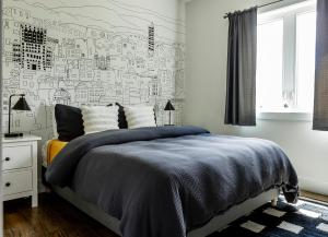 a bedroom with a bed with a black and white wall at Reynolds View in Asheville