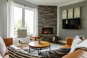 a living room with a couch and a fireplace at Reynolds View in Asheville