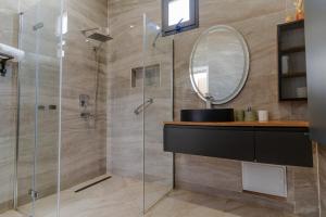 a bathroom with a shower with a sink and a mirror at Villa Socé Saly Joseph in Mbour +22 photos