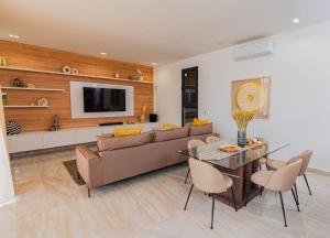 a living room with a couch and a table at Villa Socé Saly Joseph in Mbour