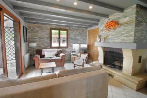 a living room with a couch and a fireplace at Le petit belvédère chalet avec piscine & vue lac in Ontex