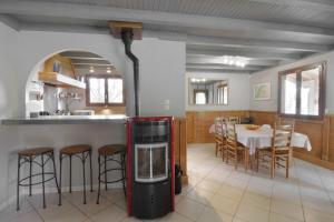 a kitchen and dining room with a red refrigerator at Le petit belvédère chalet avec piscine & vue lac in Ontex +12 photos