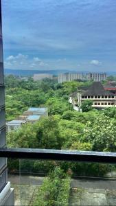 a view of a city with buildings and trees at Rouyame room by greenpark apartment in Seturan