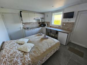 a bedroom with a bed with two pillows on it at La petite bulle d'Aurel in Quesques
