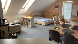 a bedroom with a bed and a table and chairs at Apartmán pod lesom in Bojnice