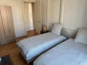 a bedroom with two beds and a night stand at L'authentique - Hyper centre et Gare in Saint-Brieuc +3 photos