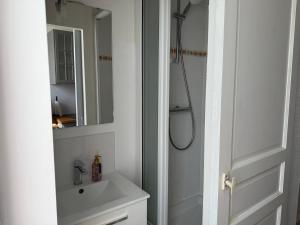 a white bathroom with a shower and a sink at L'authentique - Hyper centre et Gare in Saint-Brieuc