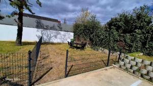 a fence with a bench in front of a building at Lenkev Living Aparts, Free Parking! in Vienna