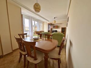 a dining room with a wooden table and chairs at La Espina, en Somo - 30024 in Somo