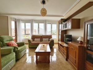 a living room with a couch and a coffee table at La Espina, en Somo - 30024 in Somo