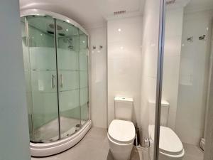 a bathroom with a glass shower and a toilet at La Espina, en Somo - 30024 in Somo +7 photos