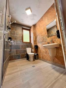 a bathroom with a toilet and a sink at Boutique Villas Murgavets Pamporovo in Pamporovo