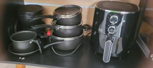 a group of pots and pans sitting on a shelf at kitnet in Rio Verde +9 photos