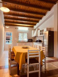 a kitchen with a table with chairs and a refrigerator at Casa quinta soñada! in Pocito
