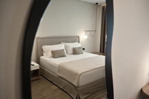 Postel nebo postele na pokoji v ubytování Asters Hotel