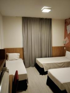 Postel nebo postele na pokoji v ubytování Hotel Cassino Tower Piracicaba by Nacional Inn