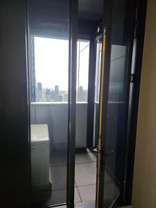 an open door to a room with a window at Melbourne's Premium on Collins in Melbourne