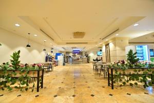 a banquet hall with tables and chairs and flowers at Abraj Al Tayseer Tuwa Hotel in Makkah