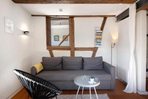 a living room with a couch and a table at Ferienhaus Hildahüsli in Badenweiler