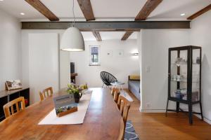 a dining room and living room with a table and chairs at Ferienhaus Hildahüsli in Badenweiler