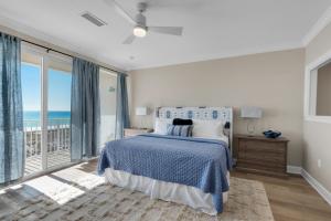 a bedroom with a bed with a view of the ocean at Beach Baby by Gulf Coast Getaways in Navarre +29 photos