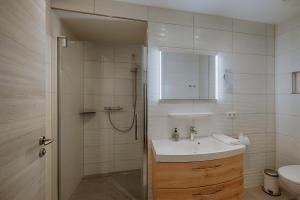 a white bathroom with a sink and a shower at Zur Eiche in Ahlbeck +81 photos